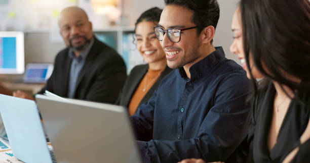 istock Man, presenter and collaboration with team in office for startup, strategy or business planning in New York. People, diversity and laugh at joke for work, technology or online documents for meeting 2056273238