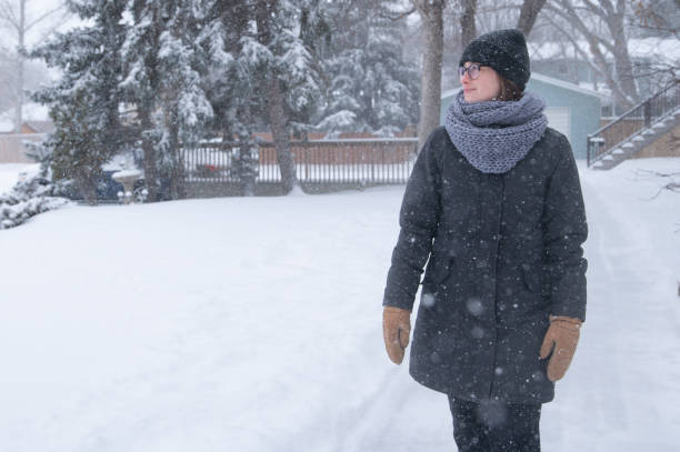 istock Woman walking in winter snowfall 2056288762