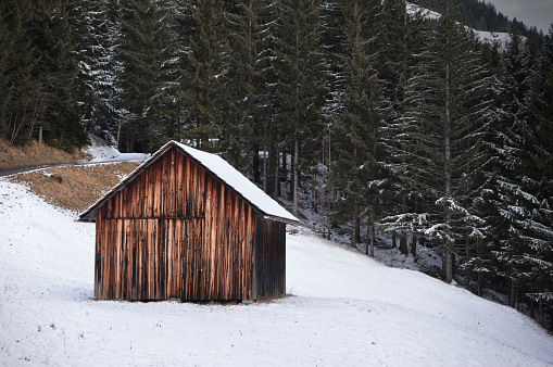 A small cottage in winter in the mountains