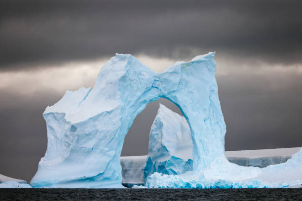 istock Antarctic landscape framed by an arch in an iceberg. 2056328662