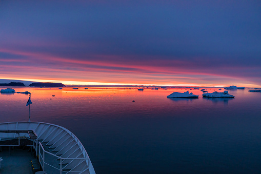 Departing ship among the ice floes on lake Baikal in Listvyanka.The mouth of the Angara.