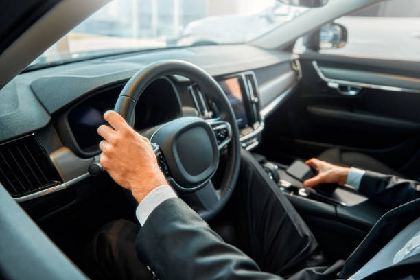 istock Businessman in a black suit in a car. 2056335730