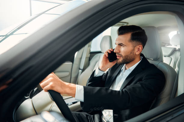istock Businessman in a black suit in a car. 2056335736