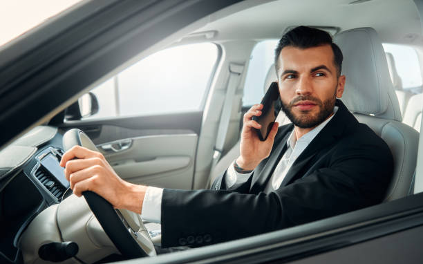 istock Businessman in a black suit in a car. 2056335867