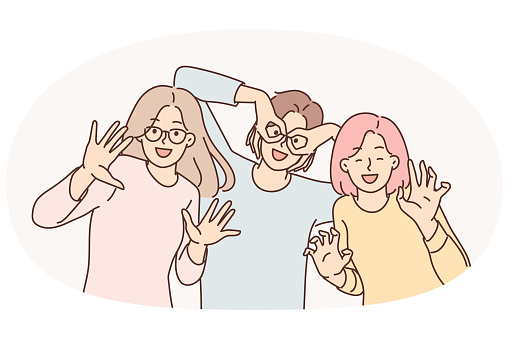 Three happy girls of friend have fun making funny faces and putting fingers to faces instead of glasses. Positive women dressed in casual clothes pose together for commemorative photo