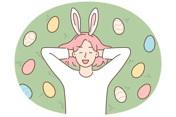 Vector illustration of Funny girl with rabbit ears lies on grass among colorful Easter eggs and smiles broadly