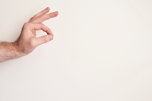 Photo of a person making a hand sign