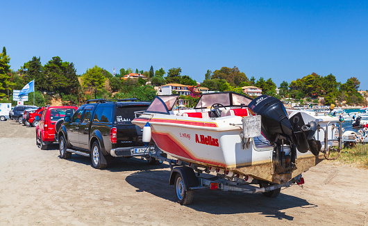 Zakynthos, Greece - August 17, 2016: Pleasure motor boat is on a car trailer on a summer day