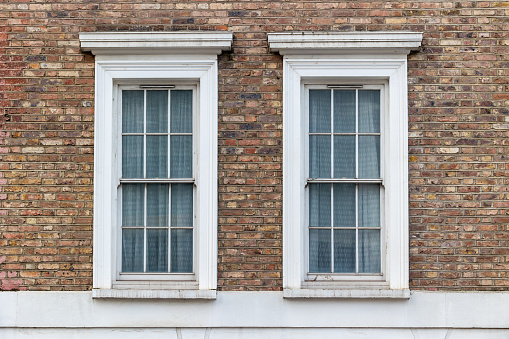 Apartment windows from brick facade of a building in New York City.