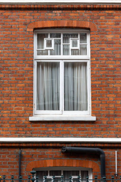 istock classic white windows of typical london architecture with red brick wall 2056400340