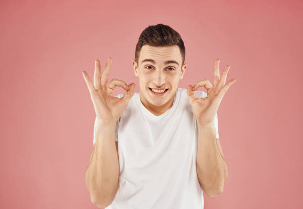 istock happy guy gesturing with his hands and showing fingers to the side emotions model 2056438838