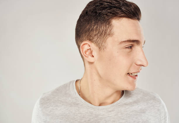 istock handsome man fun in white t-shirt close-up emotions 2056439350
