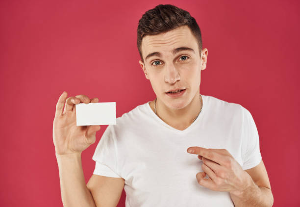 istock A man with a business card on a red background gestures with his hands cropped view 2056440417