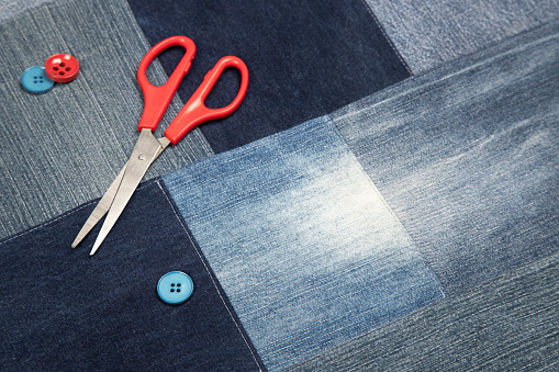 Sewing kit on Blue denim fabric background