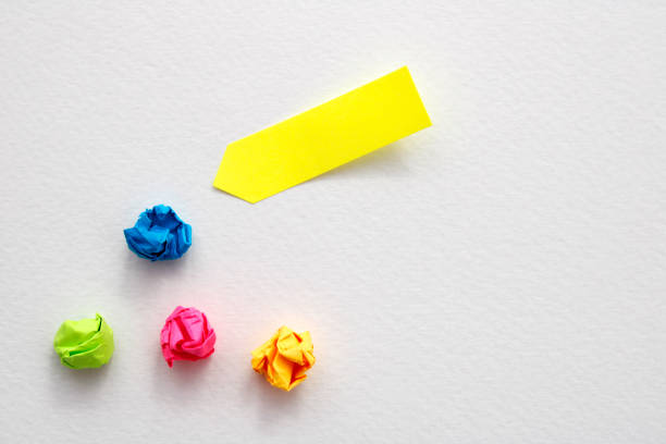 istock Yellow note next to other crumpled and discarded ones 2056463312
