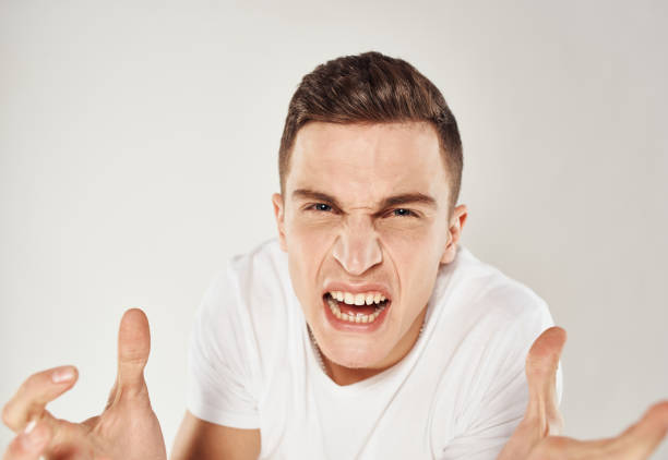 portrait of asian man wearing blue shirt being angry