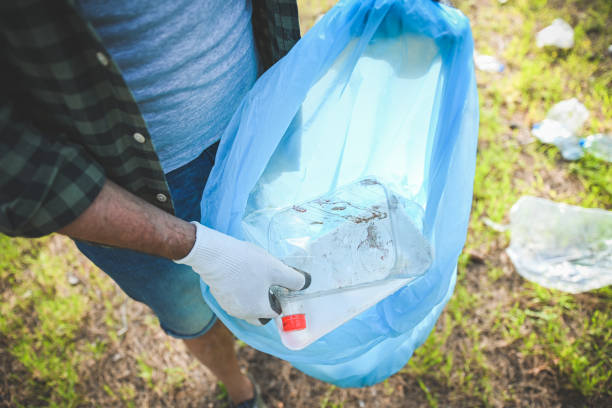 istock male volunteer collecting garbage in the forest 2056468569