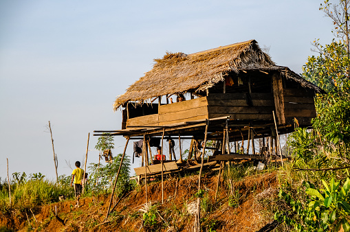 Merek, North Sumatra, Indonesia - January 28th 2024:  Typical Sumatran rural residential house with a large satellite dish antenna