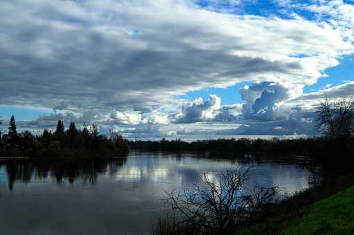 Wide angle view of the Sacramento River, with storm clouds in the background.

Taken in Sacramento, California, USA