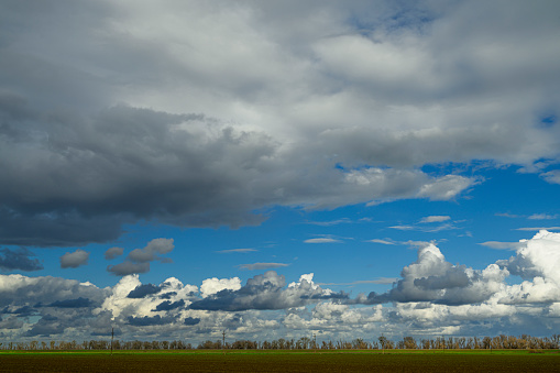 Wide view of storm clouds over the Sacramento Valley farmland.  In the background are the Sacramento River levees.\n\nTaken in Sacramento, California, USA