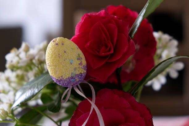 Happy Easter. Colorful Easter chocolate eggs with cherry blossoms flat lay on blue background. High quality photo