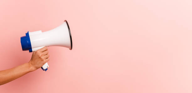 istock Unrecognizable person with megaphone in pink background 2056572177