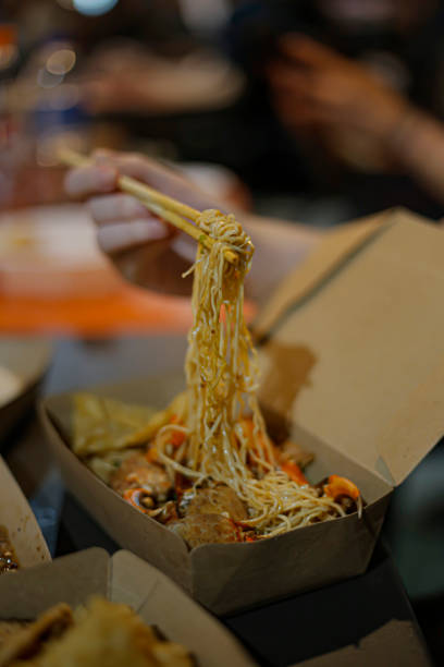 istock Chopstick noodles in a brown packaging box on a bokeh background 2056737911