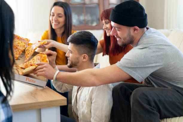 istock Friends eating pizza at home 2056740010