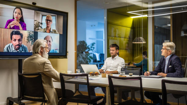 istock Business people video conferencing in board room 2056746544