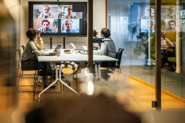 istock Business people video conferencing in board room 2056746547