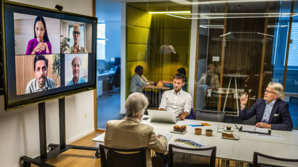 istock Business people video conferencing in board room 2056746549