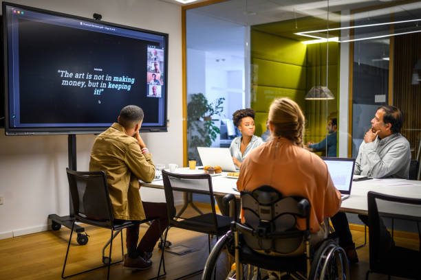 istock Business people video conferencing in board room 2056746552