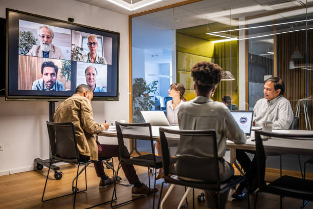 istock Business people video conferencing in board room 2056746709