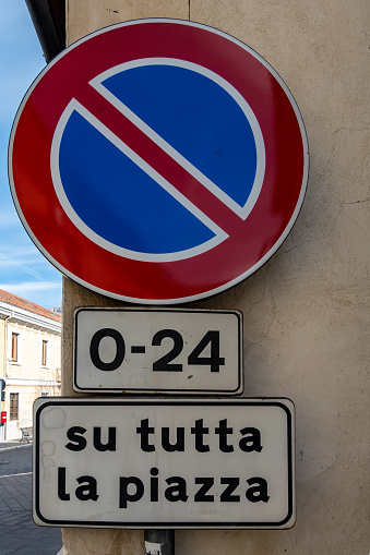 Pratola, Italy A street sign i Italian at a roundabout says No Parking anytime on the whole square, 0-24 S Tutta la piazza.