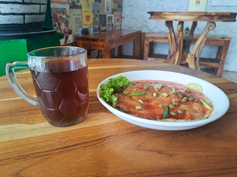 Fuyunghai - Made From Egg, Vegetables And Sweet Sour Sauce. Served With Tea In Cup. Food And Drink Menu.
