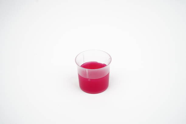 Cough Syrup medicine in a cup concept background