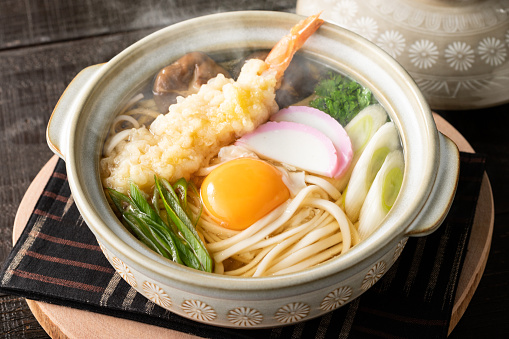 Delicious hot pot fried udon with lots of ingredients