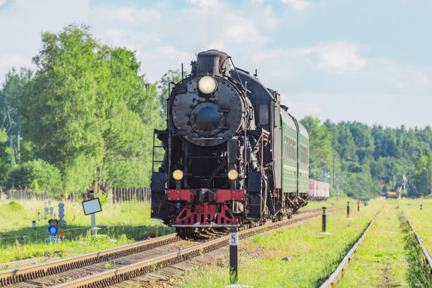 istock Retro steam train moves in the forest. 2056878581