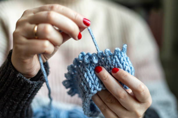 istock Hands of a woman knitting. 2056892904