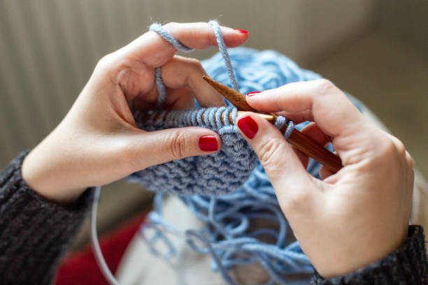 istock Hands of a woman knitting. 2056892915