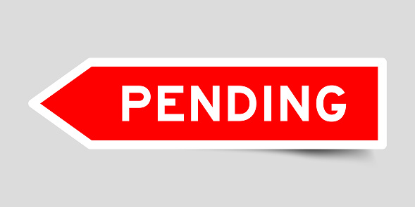 Red color arrow shape sticker label with word pending on gray background