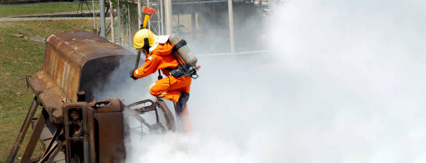 istock Firefighter Rescue training in fire fighting extinguisher. Firefighter fighting with flame using fire hose chemical water foam spray engine. Fireman wear hard hat, safety suit uniform for protection 2056993071