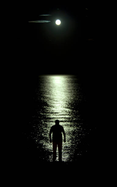 istock Man standing in the moon beam 2057003865