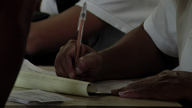 Schoolgirl Writing in Her Notebook during A Class in an Argentine Public School. Close Up.