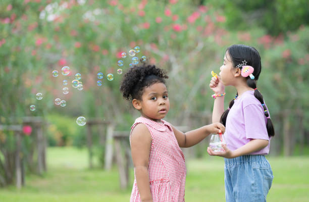 istock Girls in the park with blowing air bubble 2057076242