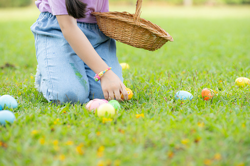 Children enjoying outdoor activities in the park including a run to collect beautiful Easter eggs.