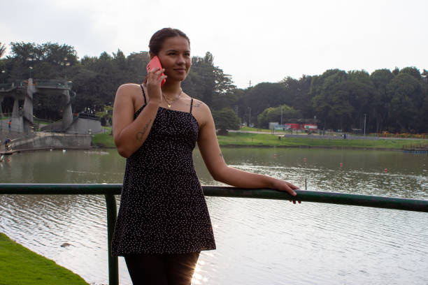 Beautiful young woman doing remote work outside