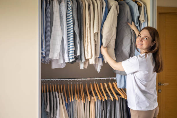 istock Elegant woman, she is decluttering her wardrobe and choosing clothes 2057129697