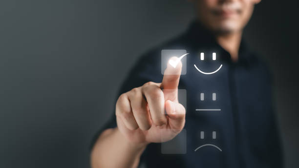 istock Customer service and Satisfaction concept, Business people are touching the virtual screen on the happy Smiley face icon to give satisfaction inservice. rating very impressed. 2057141748