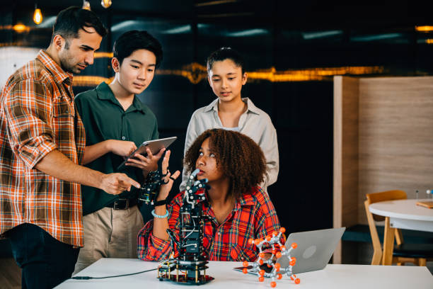 istock In a classroom at school students and teacher study and experiment on a robotic arm. Encouraging innovation teamwork and practical learning in education. Robot hand. Innovation and technology concept 2057147515
